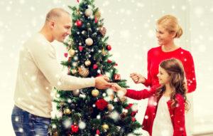 family decorating christmas tree