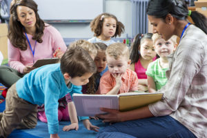 teacher giving storytime to kids